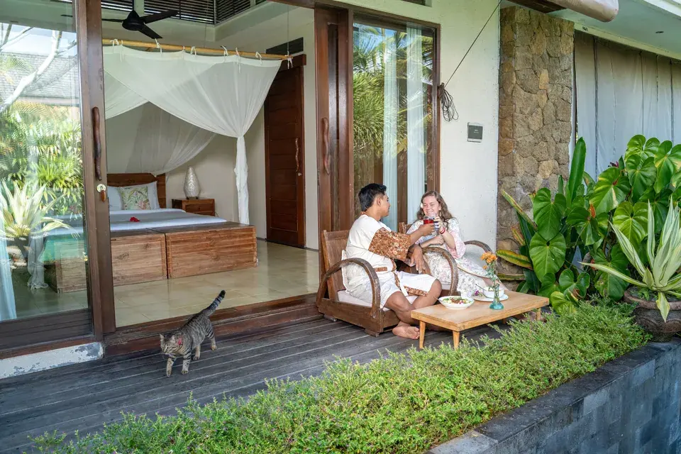 A bedroom and deck beside the garden and pool