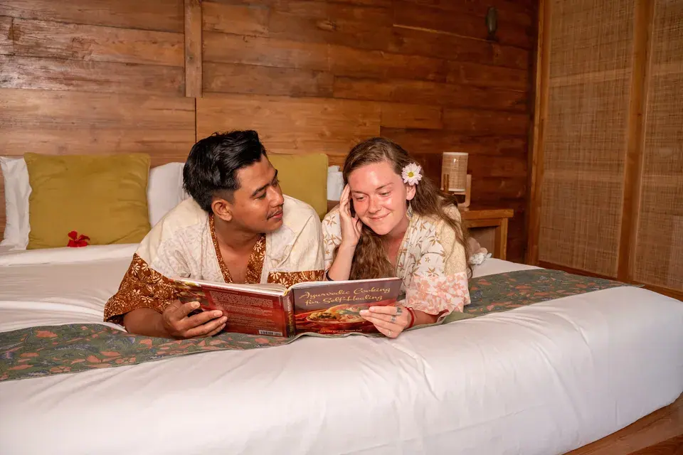 Guests relaxing on the bed in a wooden bedroom