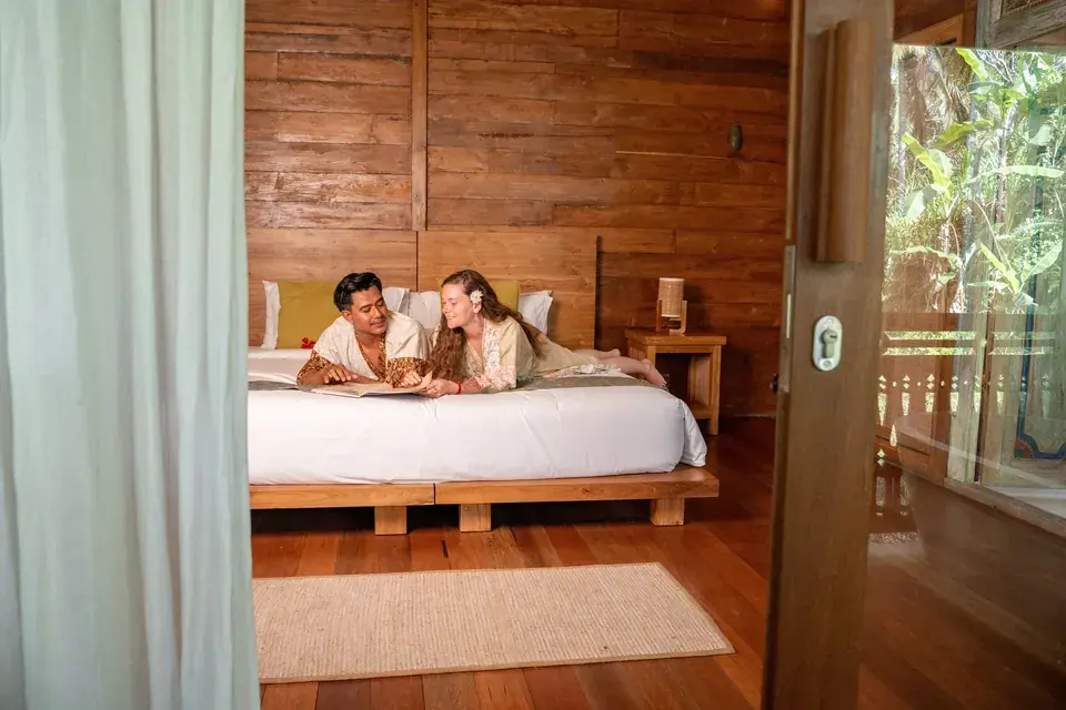 A wooden bedroom opening towards the verandah