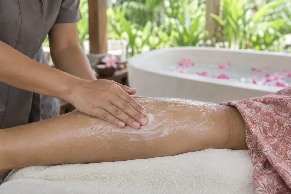 A leg scrub with a flower bath prepared nearby