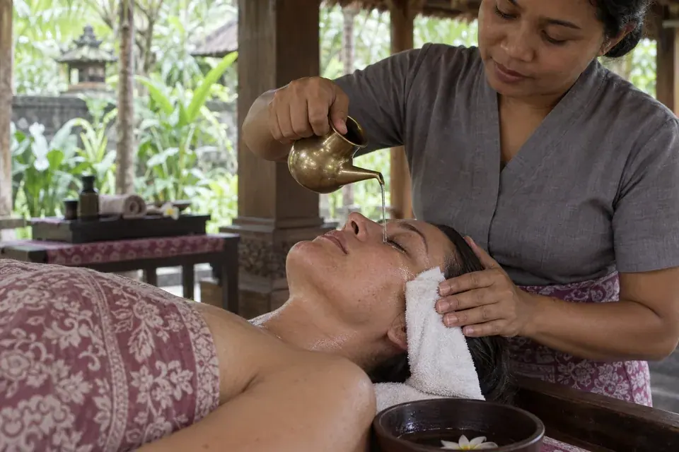 A fine stream of herbal liquid over a closed eyelid
